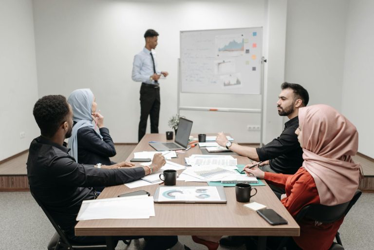 Professionals in a modern office engaged in a business meeting, focusing on teamwork and strategy.
